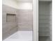 Bathroom with tiled shower and storage closet at 13850 Se 42Nd Ave, Summerfield, FL 34491