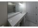 Modern bathroom with a white vanity and a large mirror at 13850 Se 42Nd Ave, Summerfield, FL 34491