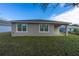 Rear view of the house, showcasing a covered patio at 13850 Se 42Nd Ave, Summerfield, FL 34491