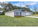 House exterior with landscaping and a driveway at 13850 Se 42Nd Ave, Summerfield, FL 34491