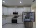 Modern kitchen with stainless steel appliances and white cabinetry at 13850 Se 42Nd Ave, Summerfield, FL 34491