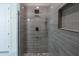 Modern shower with gray tile and rainfall shower head at 13850 Se 42Nd Ave, Summerfield, FL 34491