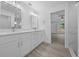 Modern bathroom with double vanity, white cabinets and a view into bedroom at 45 Water Trak, Ocala, FL 34472