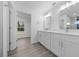 Modern bathroom with double vanity, white cabinets, and a walk-in shower at 45 Water Trak, Ocala, FL 34472