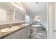 Modern bathroom featuring dual sinks, a soaking tub, and wood-look flooring at 11837 Se 165 Ave, Ocklawaha, FL 32179