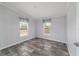 Bedroom features wood-look flooring, gray walls, and two double hung windows at 11837 Se 165 Ave, Ocklawaha, FL 32179