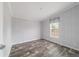 Bedroom features wood-look flooring, gray walls, one double hung window, and white trim at 11837 Se 165 Ave, Ocklawaha, FL 32179