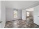 Inviting bedroom with a view, neutral walls, and light gray wood floor at 11837 Se 165 Ave, Ocklawaha, FL 32179