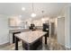 Modern kitchen featuring hardwood flooring, stainless steel appliances, and a center island with pendant lighting at 11837 Se 165 Ave, Ocklawaha, FL 32179