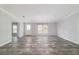 Airy living room boasting wood-look floors, an entry door, and natural light from the window at 11837 Se 165 Ave, Ocklawaha, FL 32179