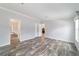 Bright and airy living room featuring stylish wood-look flooring and neutral wall colors at 11837 Se 165 Ave, Ocklawaha, FL 32179