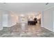 Living room with wood-look floors and an open floor plan, leading into kitchen with island at 11837 Se 165 Ave, Ocklawaha, FL 32179