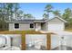 Inviting exterior of a single-story home with a gray facade, attached garage, and well-maintained lawn at 24780 Nw Hillsdale Ave, Dunnellon, FL 34431