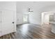 Spacious living room with modern floors, fresh paint, and a contemporary ceiling fan at 24780 Nw Hillsdale Ave, Dunnellon, FL 34431