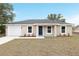 Charming single-story home showcasing a neutral color scheme, attached garage, and manicured front yard at 2815 Sw 147 Ter, Ocala, FL 34481