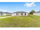 Inviting single-Gathering home featuring a lush green lawn, modern design elements and mature landscaping at 3514 Sw 149 Ct, Ocala, FL 34481