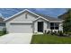 Charming single-story home with a two-car garage and manicured lawn at 8457 Las Palmas Way, Wildwood, FL 34785