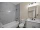 Bathroom featuring tub with marble-like tiling, a toilet, and a vanity with a bright mirror at 10250 Sw 82Nd Ct, Ocala, FL 34481