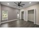Bedroom with wood floors, ceiling fan, and large closets at 10250 Sw 82Nd Ct, Ocala, FL 34481