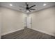 Simple bedroom with wood-look floors and an adjacent bathroom at 10250 Sw 82Nd Ct, Ocala, FL 34481