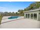 Backyard view of the home with pool and patio at 10250 Sw 82Nd Ct, Ocala, FL 34481
