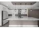 Modern kitchen featuring a large island, sleek white cabinetry, and stainless steel appliances at 10250 Sw 82Nd Ct, Ocala, FL 34481