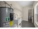Laundry room with utility sink, shelving, and separate toilet at 10250 Sw 82Nd Ct, Ocala, FL 34481