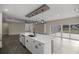 Spacious living room with a view of backyard, complemented by a large kitchen island at 10250 Sw 82Nd Ct, Ocala, FL 34481