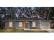 Charming home showcasing a freshly painted exterior, manicured lawn, and a welcoming front entrance at 13212 Sw 113 Ln, Dunnellon, FL 34432