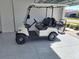 White golf cart with black seats in garage at 8829 Sw 59Th Lane Rd, Ocala, FL 34481