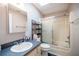 Bathroom featuring shower/tub combo, vanity with sink, and shelves at 10817 Se 51St Ave, Belleview, FL 34420