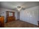 Neutral bedroom with ceiling fan, closet, dresser, and standard-sized doorway at 10817 Se 51St Ave, Belleview, FL 34420