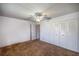 Spacious bedroom features a ceiling fan, closet, and carpeted flooring, offering a versatile and comfortable living space at 10817 Se 51St Ave, Belleview, FL 34420