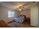 A cozy bedroom featuring a bed, nightstand, and a window for natural light at 10817 Se 51St Ave, Belleview, FL 34420