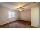 Inviting bedroom featuring a ceiling fan, a window with blinds, and carpeted flooring, creating a cozy space at 10817 Se 51St Ave, Belleview, FL 34420