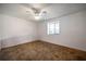 Comfortable bedroom with a ceiling fan, a window with blinds, and carpeted flooring, creating a serene and inviting space at 10817 Se 51St Ave, Belleview, FL 34420