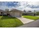 Charming single-story home featuring a well-manicured lawn and an attached one car garage at 10817 Se 51St Ave, Belleview, FL 34420