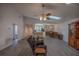 Open concept living room with modern gray flooring, neutral walls, and a view to the kitchen and dining area at 10817 Se 51St Ave, Belleview, FL 34420