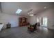 Open-concept living room features a vaulted ceiling, skylight and a sliding door to the outside at 10817 Se 51St Ave, Belleview, FL 34420