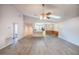 Bright living room featuring vaulted ceilings, a ceiling fan, and wood-look flooring, creating a modern and airy atmosphere at 10817 Se 51St Ave, Belleview, FL 34420
