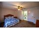 Comfortable main bedroom with ceiling fan, closet, and access to the bathroom at 10817 Se 51St Ave, Belleview, FL 34420