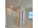 Modern bathroom with a glass-enclosed shower, neutral tile, and ample natural light at 11610 Sw 59Th Terrace, Ocala, FL 34476
