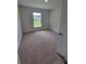 Cozy bedroom with plush carpeting, a sunny window, and a fresh, clean aesthetic at 11610 Sw 59Th Terrace, Ocala, FL 34476