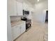 Well-equipped kitchen with white cabinets, granite countertops, and stainless steel appliances, offering a functional design at 11610 Sw 59Th Terrace, Ocala, FL 34476