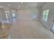 Spacious living area with light tile flooring, leading to the entryway and other rooms at 11610 Sw 59Th Terrace, Ocala, FL 34476