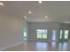 Open concept living room with neutral walls and modern tile flooring, creating a spacious feel at 11610 Sw 59Th Terrace, Ocala, FL 34476