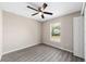 Bedroom with luxury vinyl plank flooring, ceiling fan, window, neutral paint and closet at 3165 Se 147Th Ln, Summerfield, FL 34491