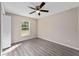 Bedroom with luxury vinyl plank flooring, ceiling fan, window, neutral paint and closet at 3165 Se 147Th Ln, Summerfield, FL 34491