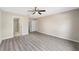 Spacious main bedroom with luxury vinyl plank flooring, ceiling fan, and ensuite bath at 3165 Se 147Th Ln, Summerfield, FL 34491