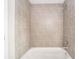 Bathroom with a tiled shower/tub combo and neutral colored tile at 90 Bay Dr, Ocklawaha, FL 32179